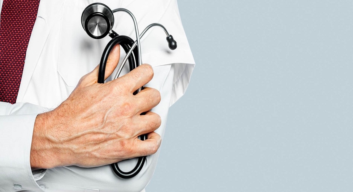 doctor's hand holding stethoscope closeup