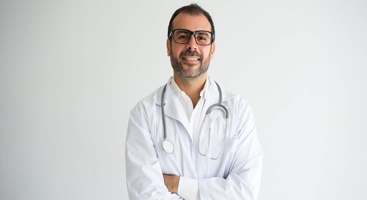 portrait successful mid adult doctor with crossed arms